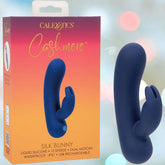 The CalExotics Cashmere Silk Bunny Rabbit Vibrator, a blue silicone dual-motor toy with 10 speeds, is shown beside its orange and pink box; it’s waterproof and USB rechargeable.